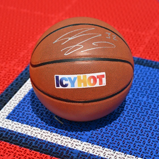 A close-up of a basket ball with the Icy Hot logo, signed by Shaquille O'Neil.